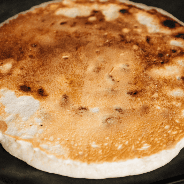 Golden, fluffy pancakes cooked on a Ninja Woodfire Grill with a smoky, wood-fired flavor.