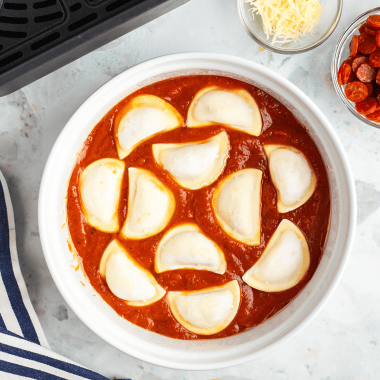 Place pierogies on top of the pizza sauce in a single layer.