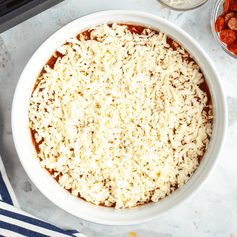 Add shredded cheese on top, and then add your favorite toppings.