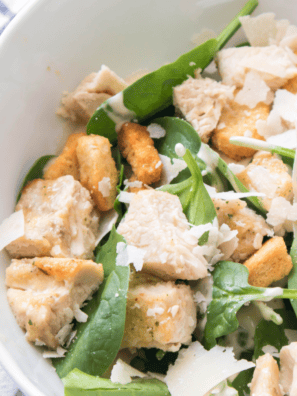 Spicy Caesar Salad with crisp romaine, spicy dressing, and crunchy croutons, garnished with Parmesan cheese.
