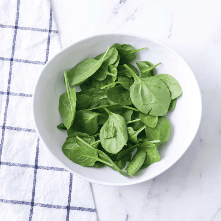 Close-up of washed, dried romaine lettuce chopped into bite-sized pieces for even dressing coverage.