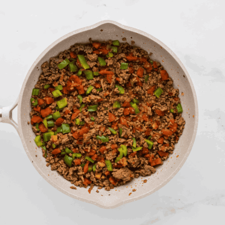 Browning seasoned ground beef in a skillet for the casserole