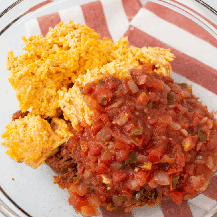 Mixing pimento cheese and salsa, then heating in an air fryer until bubbly.