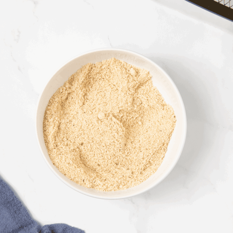 Almond flour, breadcrumbs, garlic powder, onion powder, paprika, salt, and black pepper mixed together in a bowl to make coating mixture.