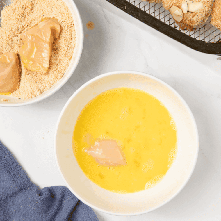 Beaten eggs in a large bowl, whisked.