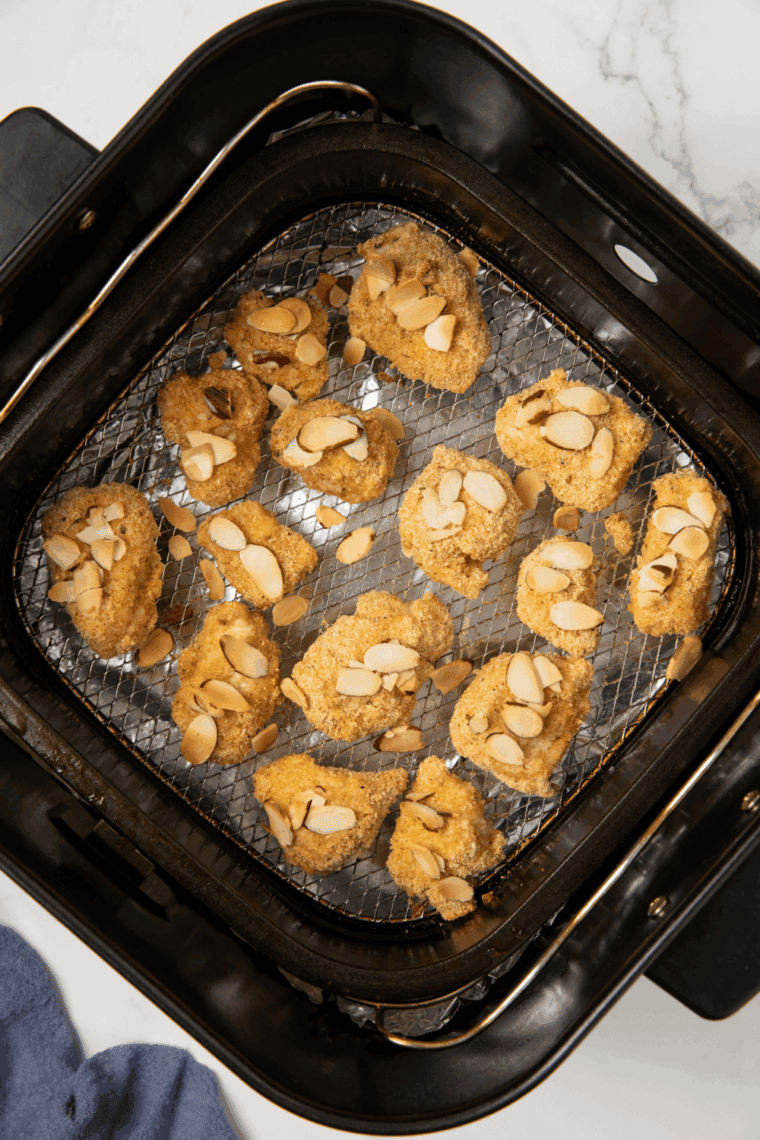 Golden, crispy Air Fryer Panda Express Almond Chicken, garnished with sliced almonds and savory sauce.