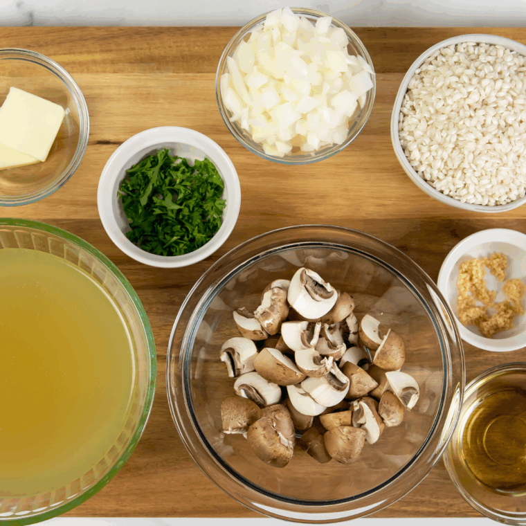 Arborio rice, mushrooms, onion, garlic, butter and broth laid out for risotto
