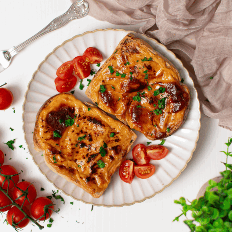 Air Fryer Welsh Rarebit with melted cheese sauce on toasted bread.
