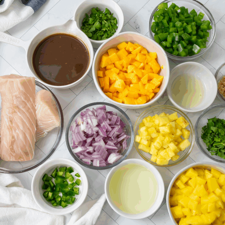 Ingredients for Blackstone mahi mahi: fillets, teriyaki sauce, garlic, and tropical salsa produce