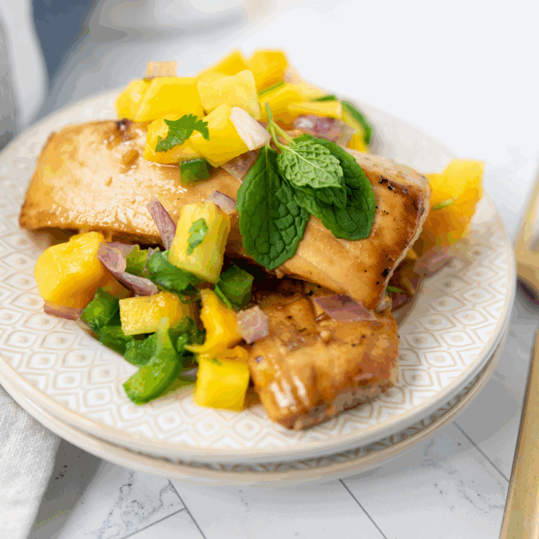 Blackstone mahi mahi fillets cooking on the hot griddle with golden, lightly seared edges