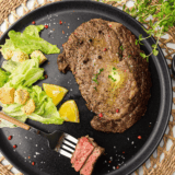 "Copycat Applebee's Bourbon Street Steak served with sizzling onions and a rich bourbon glaze, perfect for a hearty dinner."