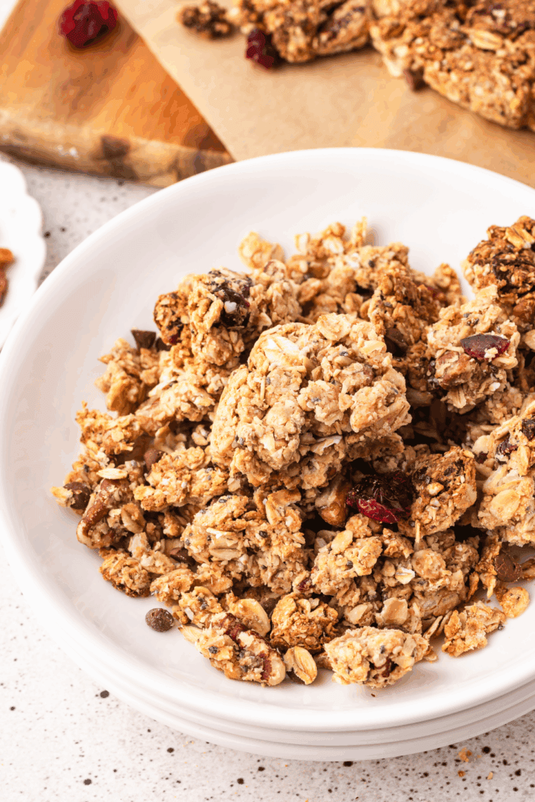 Crunchy low FODMAP granola with oats and almonds served over yogurt with fresh berries