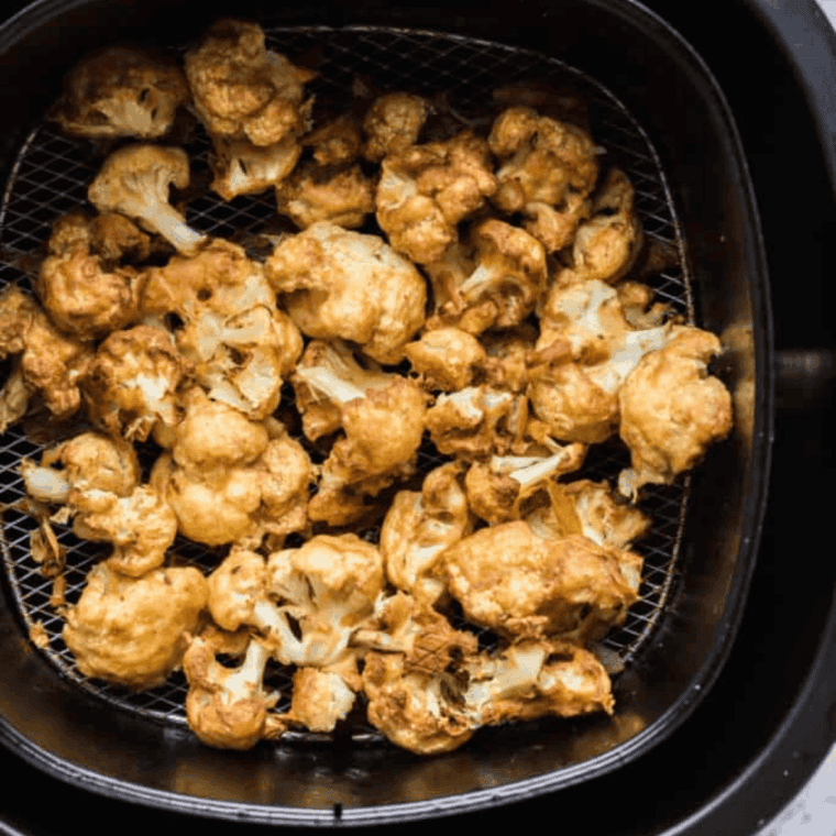 Air frying buffalo cauliflower.