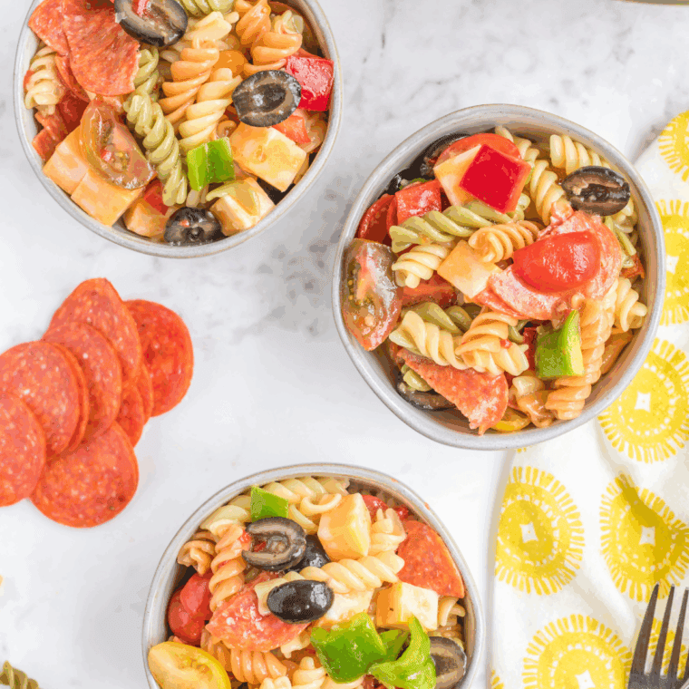 Creamy Hooters-style pasta salad with rotini and diced vegetables in a white bowl.