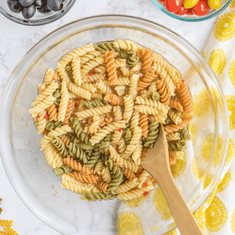 Cooked pasta tossed with salad dressing. 