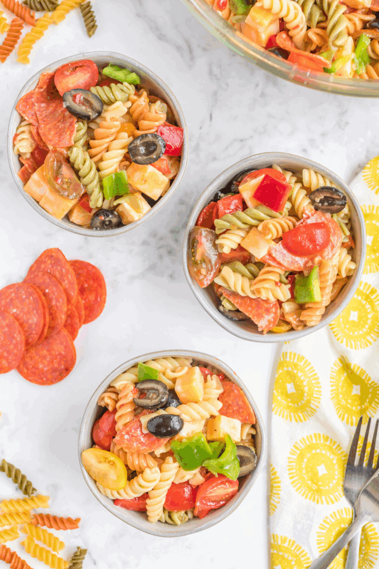 Bowl of creamy Hooters-style pasta salad with rotini and fresh vegetables.