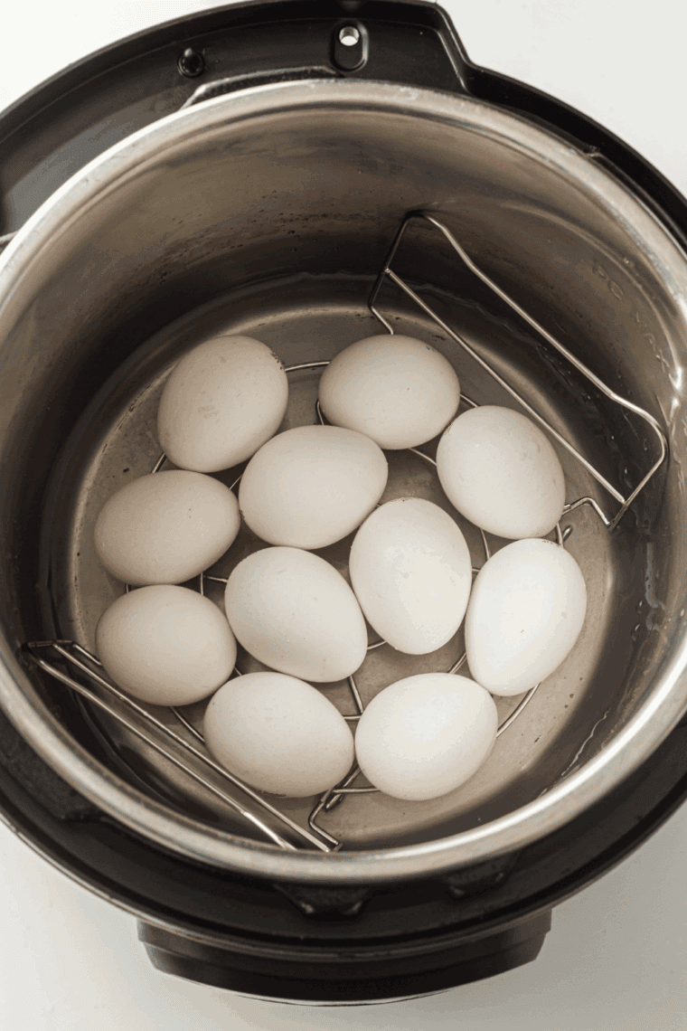 Place the hard boiled eggs into the Instant Pot Bowl. On top of the trivet is helpful, as they won't roll.