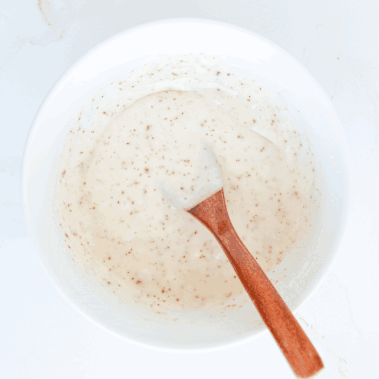 Whisking the ingredients in a large mixing bowl.