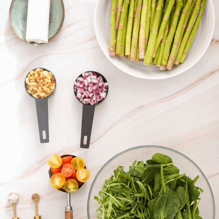 Ingredients needed for Asparagus Salad with Goat Cheese on kitchen table.