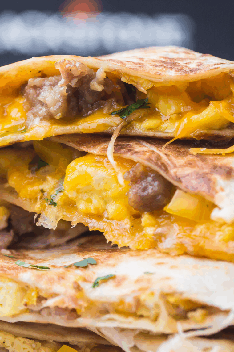 Crispy golden Blackstone breakfast quesadilla filled with eggs, sausage, bell peppers, and melted cheese