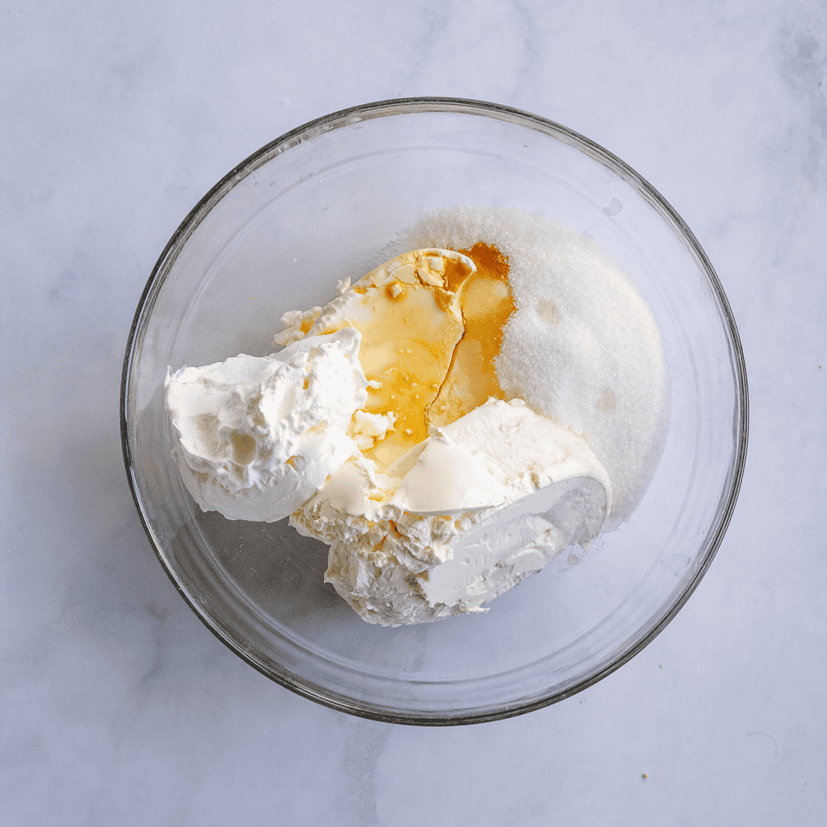 Beating cream cheese with pumpkin, spices, and eggs to make the cheesecake filling.