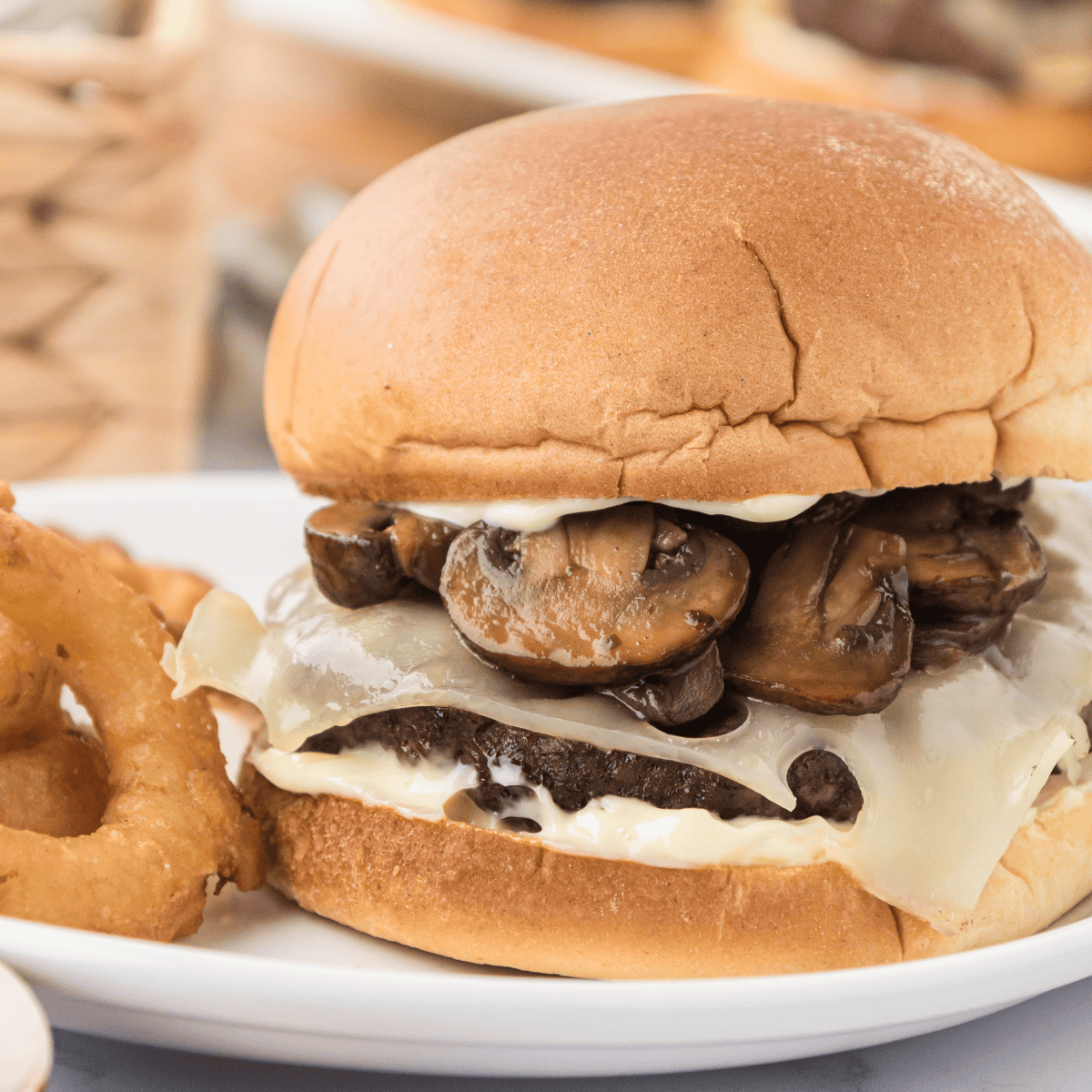 Juicy mushroom Swiss burger on a bun with melted cheese and sautéed mushrooms