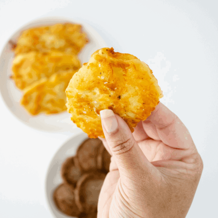 Golden, crispy Arby’s-style potato cakes stacked on a serving plate.