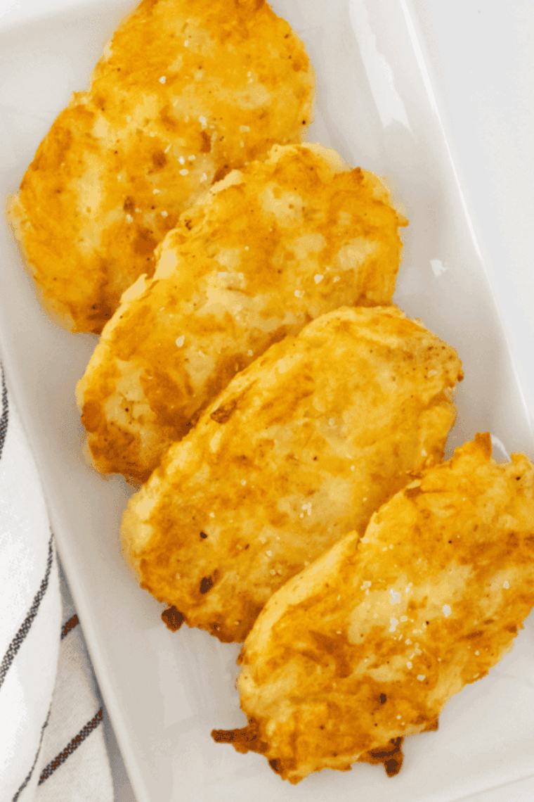 Homemade crispy Arby’s potato cakes served hot on a plate.