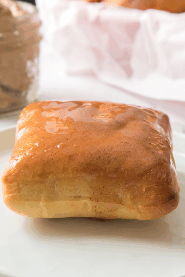 Golden Corral yeast rolls in air fryer basket brushed with melted butter