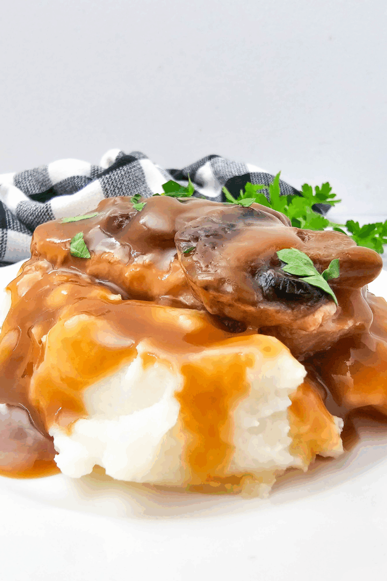 Bowl of homemade KFC copycat gravy served over mashed potatoes