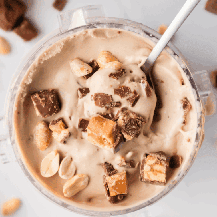 Heavy cream added to crumbly ice cream in Ninja CREAMi pint before re-spinning