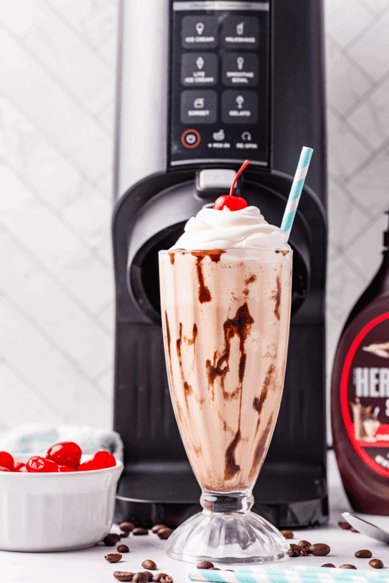 Homemade Ninja Creami McDonald’s Chocolate Milkshake served in a tall glass with whipped cream and chocolate drizzle.