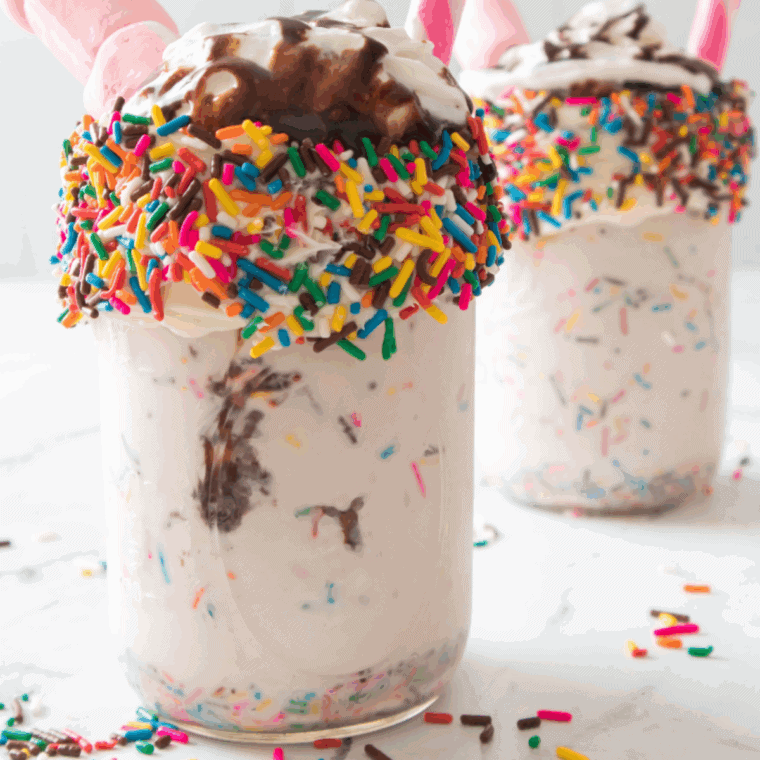 Ninja Creami McDonald’s Chocolate Milkshake in a glass with whipped cream and chocolate drizzle.