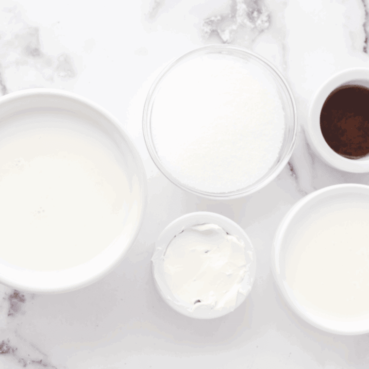 Ingredients needed for Ninja Creami Vanilla Almond Ice Cream on kitchen table.