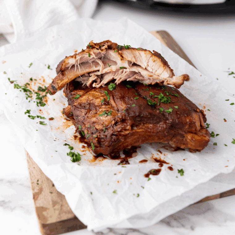 Finished slow cooker Dr Pepper ribs coated in glossy BBQ sauce