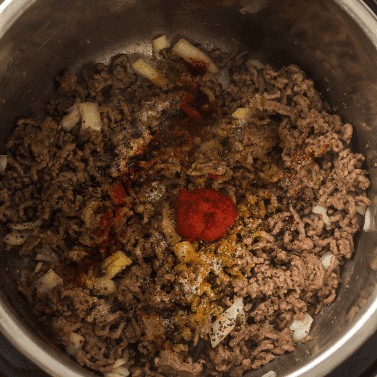 Mix chili spices and flour with the sautéed ingredients to build flavor and thicken chili.


