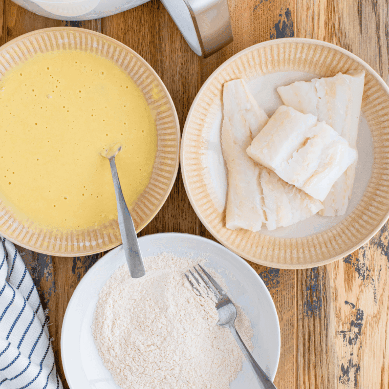 Whisking flour, baking powder, salt, pepper, and cold sparkling water into batter.