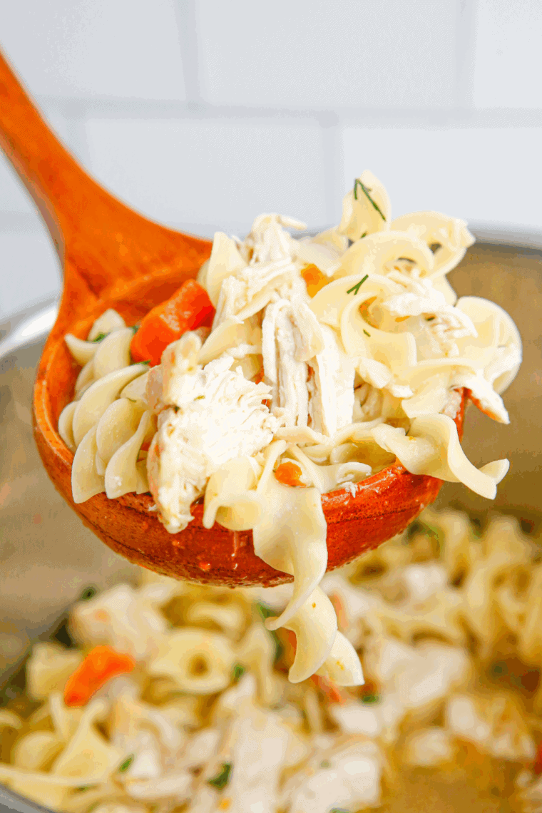 Bowl of Carrabba’s Spicy Sicilian Chicken Soup with shredded chicken, ditalini pasta, and vegetables in a rich, spicy broth.