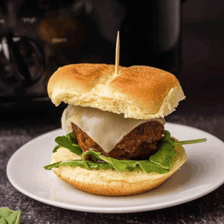Close-up of a juicy meatball slider cut in half showing marinara and melted cheese