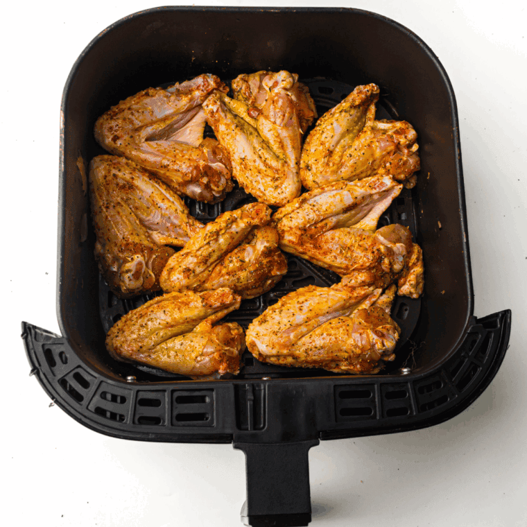 Chicken wings arranged on baking sheet and cooked until golden and crispy, or in an air fryer