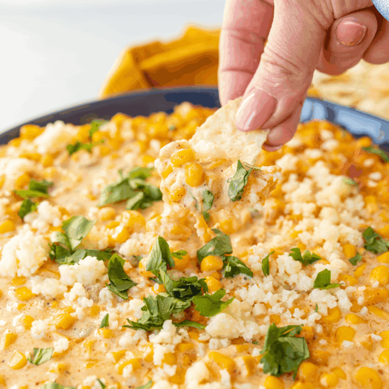 A spoonful of creamy Mexican street corn casserole lifted from the dish