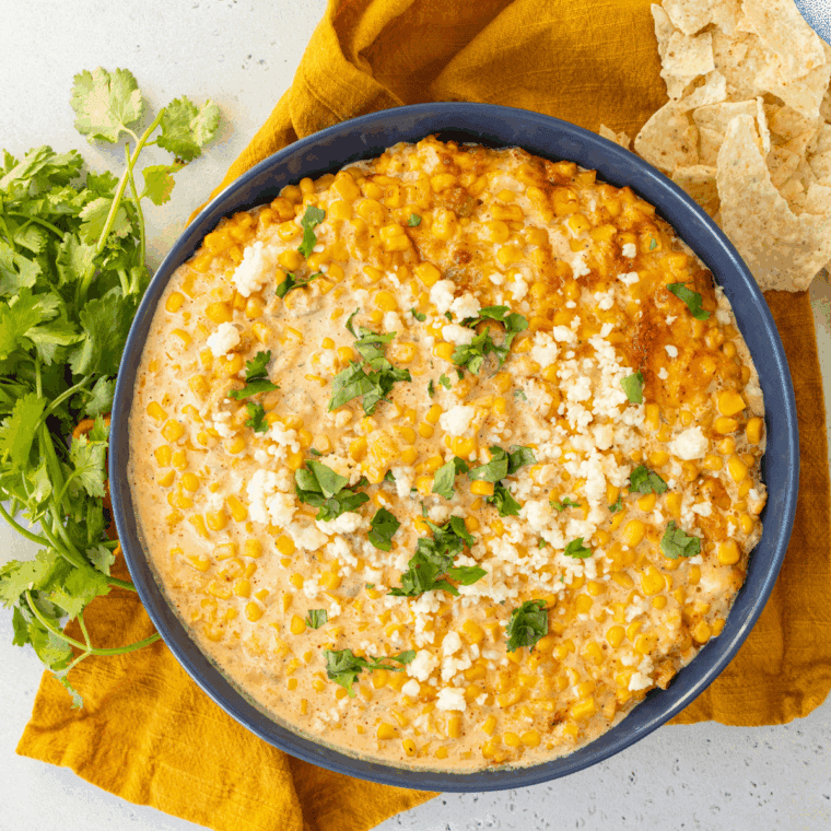 Street corn mixture spread into a 9x13 baking dish, ready for the oven