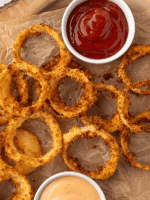 Plate of crispy, golden Hooters-style onion rings ready to serve.