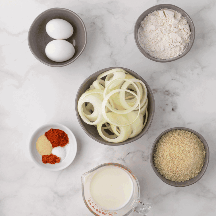 Ingredients needed for Hooters Onion Rings Recipe on kitchen table.
