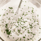 Ina Garten Buttermilk Blue Cheese Dressing served in a bowl with salad on the side.