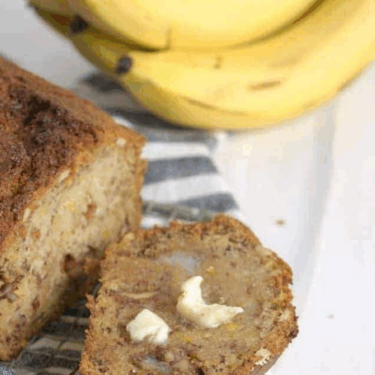 Golden brown Ina Garten banana bread loaf, sliced, with soft, moist interior and toasted pecans.
