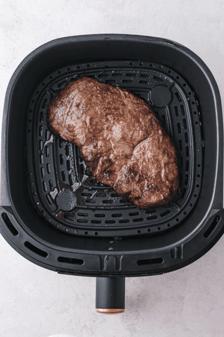 Air fryer Longhorn Renegade Sirloin steak, cooked to perfection and garnished with fresh herbs.