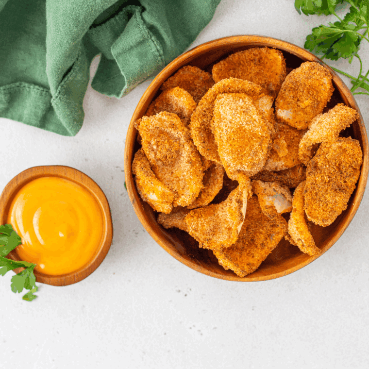 Homemade LongHorn Steakhouse Texas Tonion dipping sauce served in a small bowl with crispy onion petals for dipping