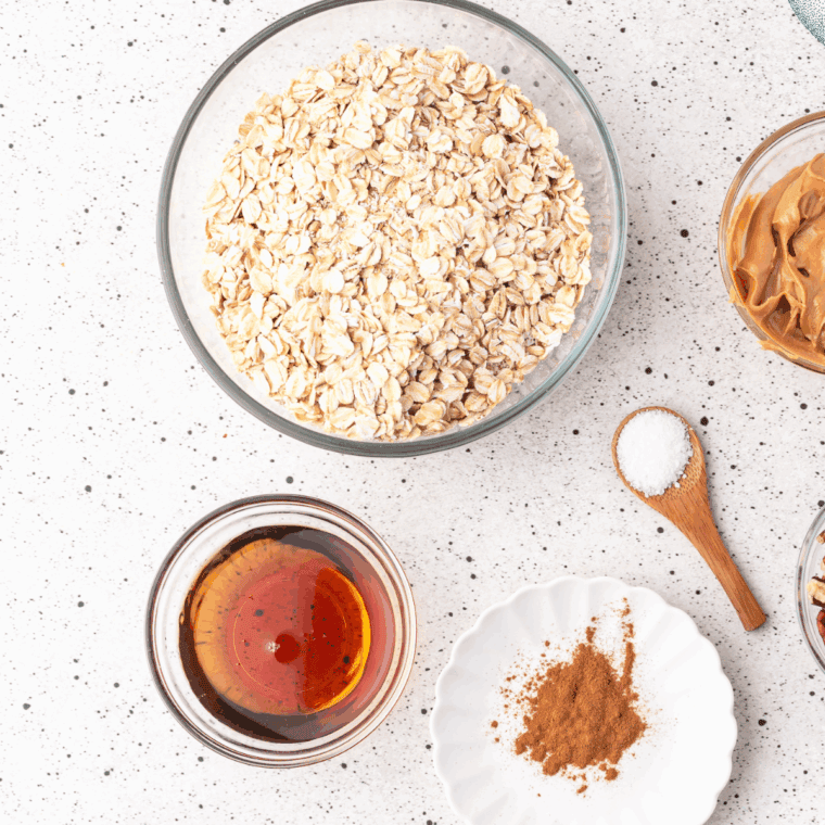 Nut-free granola ingredients: rolled oats, seeds, coconut flakes, maple syrup, and dried fruit