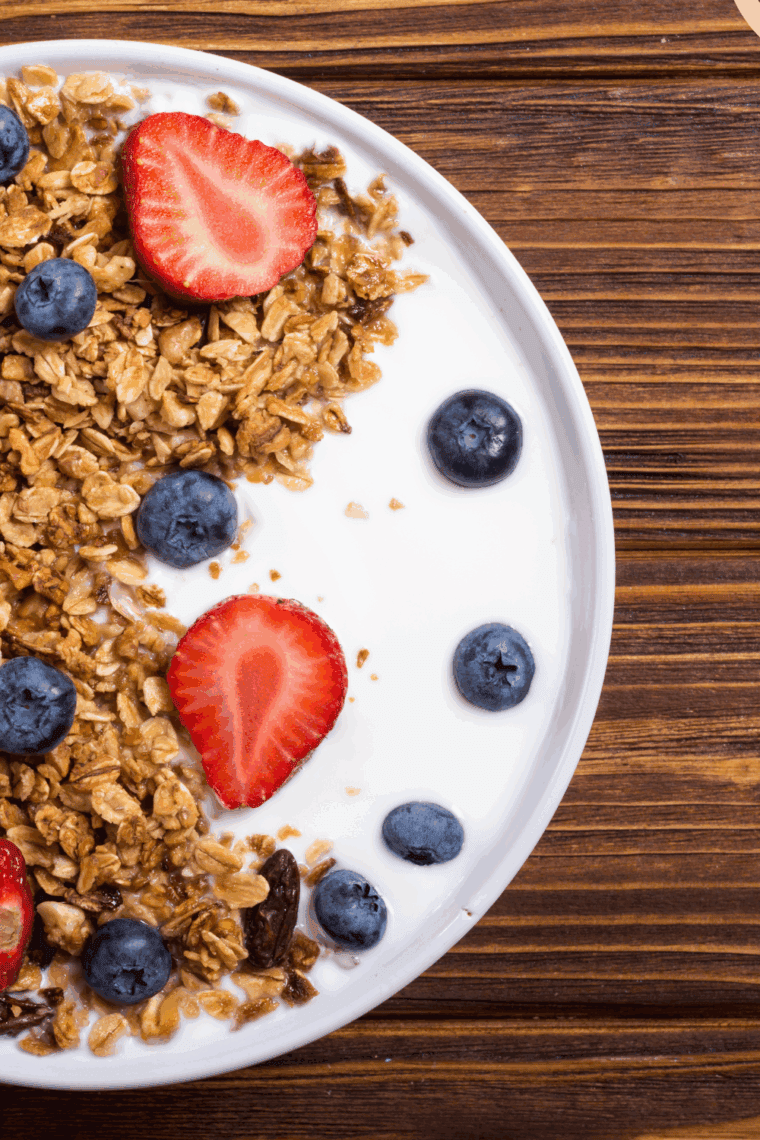 Homemade gluten-free, nut-free granola served over yogurt with fresh berries